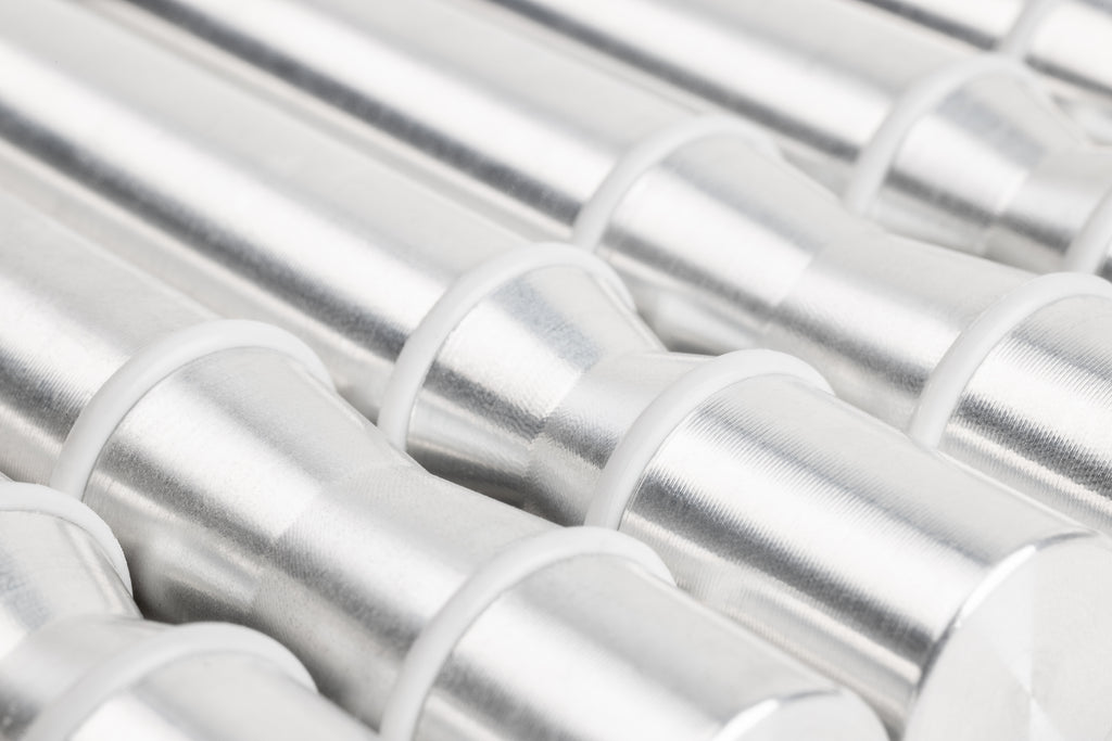 Close-up of Winepegs Nek Rite 1 Lite wall-mounted wine pegs in brushed aluminum finish, highlighting silicone o-ring detail for secure bottle placement