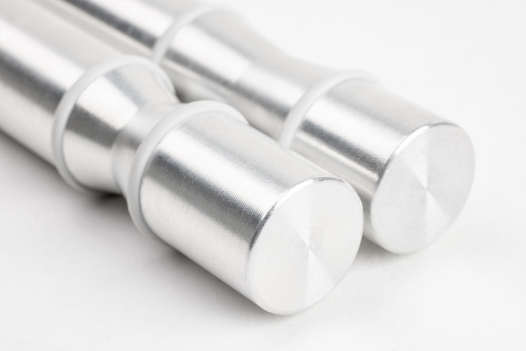 Close-up of a pair of Winepegs Nek Rite 1 Lite wall-mounted wine pegs in brushed aluminum finish with silicone o-rings for secure bottle support