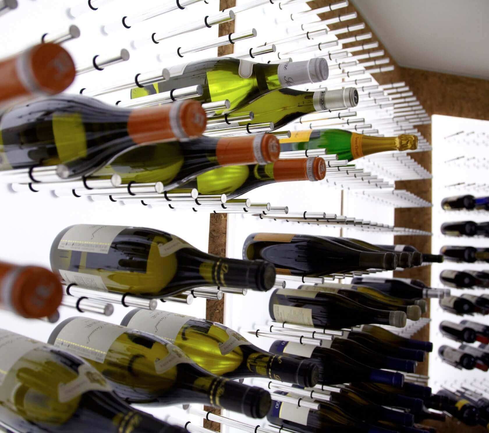 XY wine pegs series installed on backlit acrylic panel substrate
